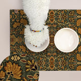 A white dog is standing on a green and gold patterned mat, with two empty bowls placed on the mat.